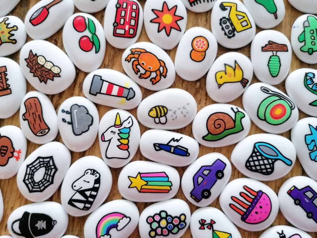 Story stones from Imagistones. Bright designs hand painted on white glass pebbles