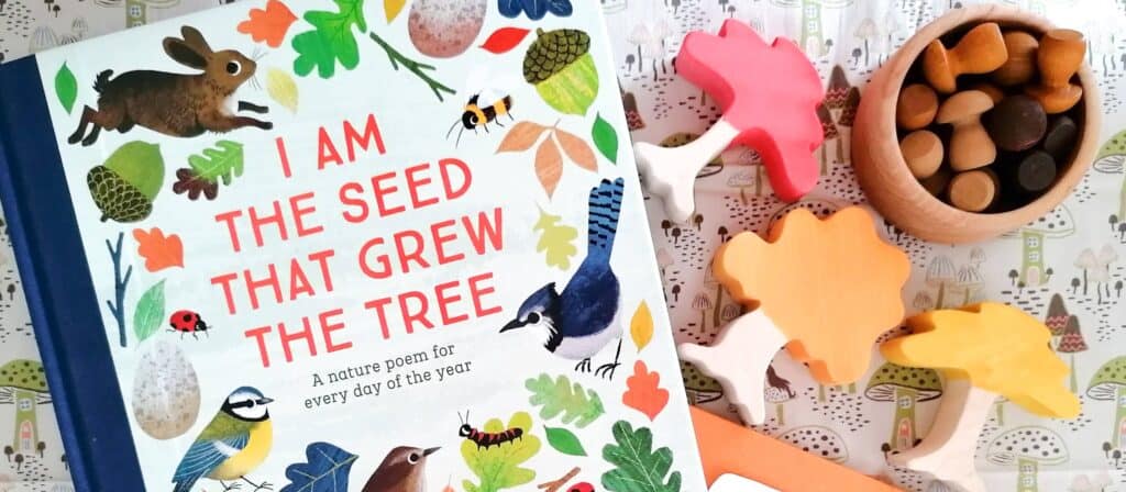 I Am the Seed That Grew the Tree Poetry book with three home dyed wooden trees in red, orange and yellow with a pot of Grapat wooden mushrooms in a pot to the right of the picture.