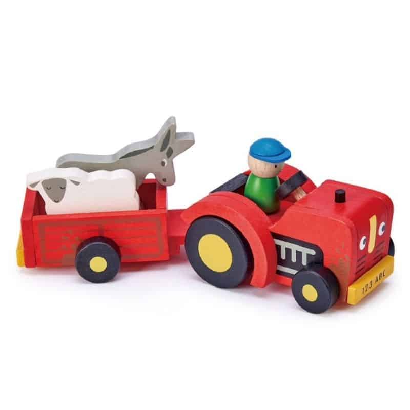wooden tractor toy with a framer in the tractor and a sheep and a donkey in the trailor.