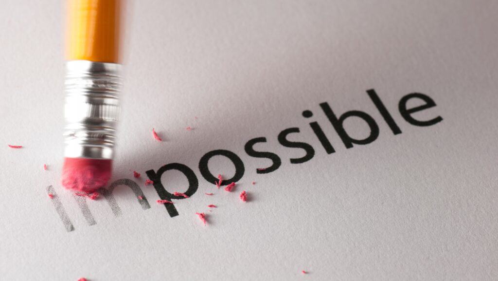 The word impossible written and then im being erased by a rubber.